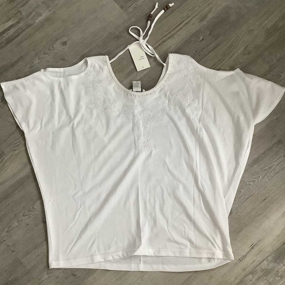 White featuring cold-shoulder cutouts and embroidery around the neckline🌻